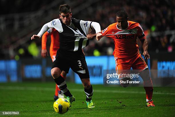 Swansea player Wayne Routledge is challenged by Davide Santon during the Barclays Premier league game between Newcastle United and Swansea City at St...