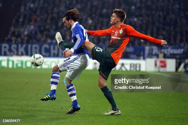 Sebastian Proedl of Bremen challenges Christian Fuchs of Schalke during the Bundesliga match between FC Schalke 04 and SV Werder Bremen at Veltins...