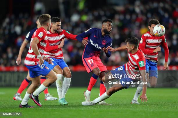 Thomas Lemar of Atletico de Madrid is tackled by Raul Torrente of Granada CF during the La Liga Santander match between Granada CF and Club Atletico...