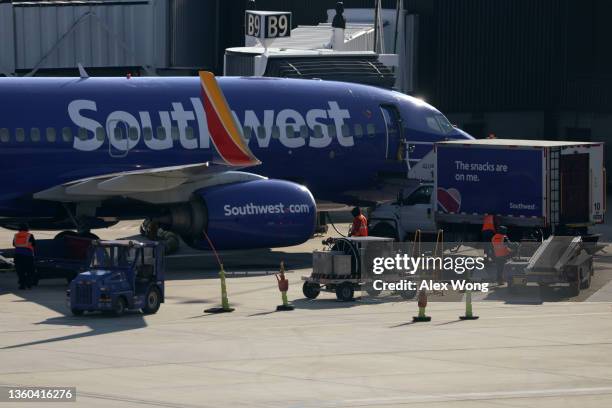 Ground crew replenishes a Southwest Airlines aircraft at Baltimore/Washington International Thurgood Marshall Airport on December 22, 2021 in...