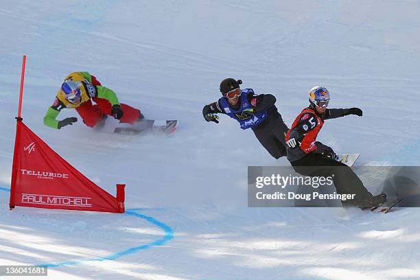 Pierre Vaultier of France leads the semifinal heat ahead of Jonathan Cheever and Alex Pullin of Australia in the team snowboardcross at the LG...