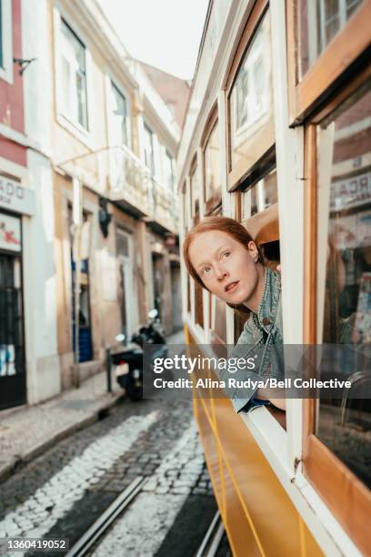 Woman leaning out of the window of a tram