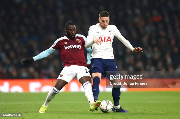 Arthur Masuaku of West Ham United and Matt Doherty of Tottenham Hotspur battle for possession during the Carabao Cup Quarter Final match between...
