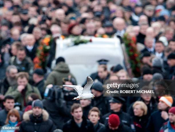 Seagull flies over mourners follows the hearse carrying the coffin of former Czech President Vaclav Havel across Charles Bridge on its way to Prague...