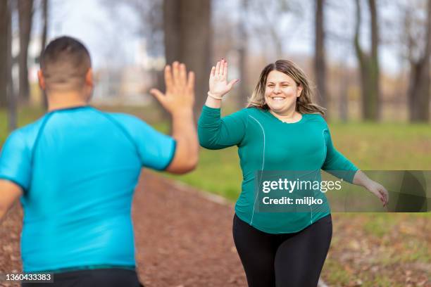 people with overweight problem running in city park - överviktig bildbanksfoton och bilder