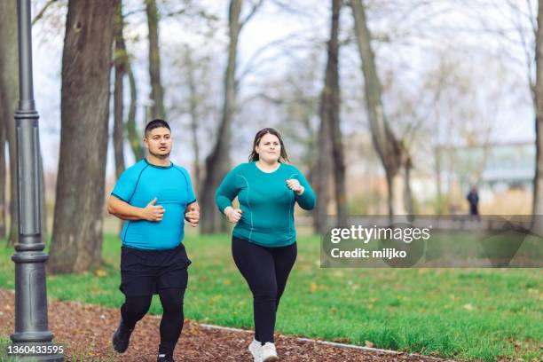 people with overweight problem running in city park - obesity imagens e fotografias de stock