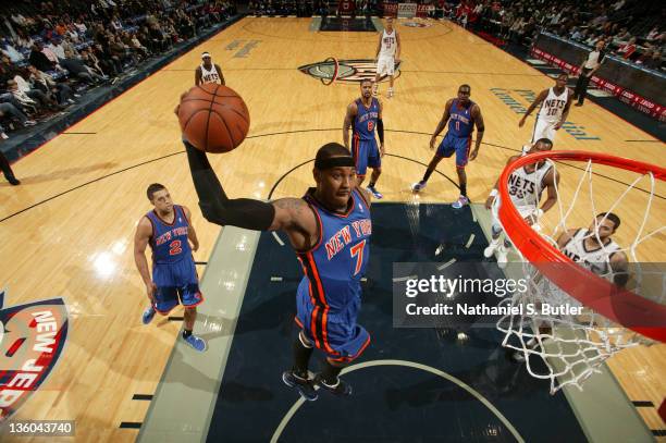 Carmelo Anthony of the New York Knicks dunks against the New Jersey Nets during the preseason game on December 17, 2011 at the Prudential Center in...