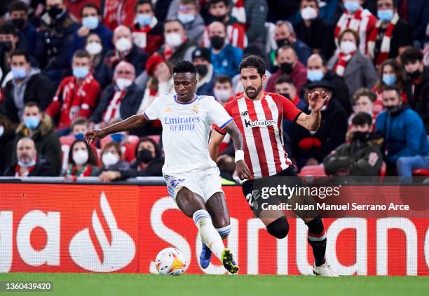 Vinicius Junior of Real Madrid duels for the ball with Raul Garcia of Athletic Club during the LaLiga Santander match between Athletic Club and Real...