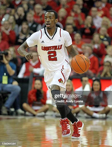 Russ Smith of the Louisville Cardinals dribbles the ball during the game against the Memphis Tigers at KFC YUM! Center on December 17, 2011 in...