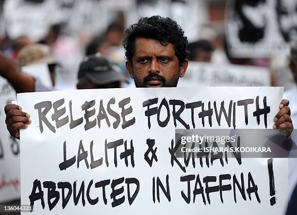 Sri Lanka's Marxist Peoples Party supporters holds a placard during a demonstration in Colombo on December 21 demanding the government take action to...