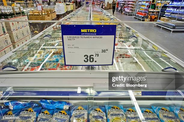 Sign displaying price of goods sits above a freezer in the frozen food section of a Metro Cash & Carry store, operated by Metro AG, in Kiev, Ukraine,...