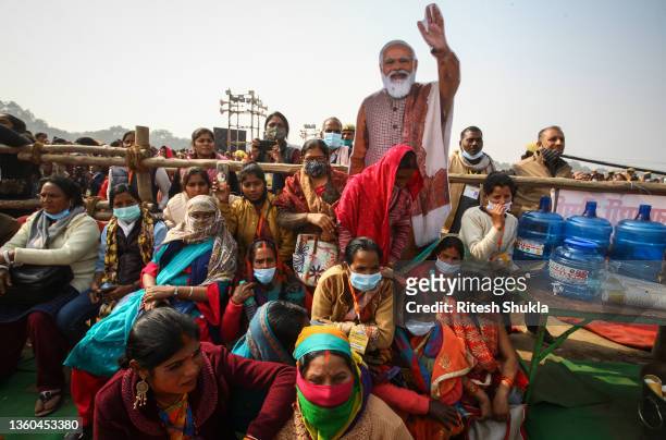 Women from various districts are seen near cut-outs of India's Prime Minister Narendra Modi at a rally held by Modi on December 21, 2021 in...