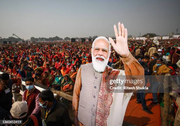 Women from various districts are seen near cut-outs of India's Prime Minister Narendra Modi at a rally held by Modi on December 21, 2021 in...