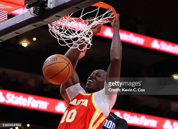 Gorgui Dieng of the Atlanta Hawks dunks against Chuma Okeke of the Orlando Magic during the first half at State Farm Arena on December 22, 2021 in...
