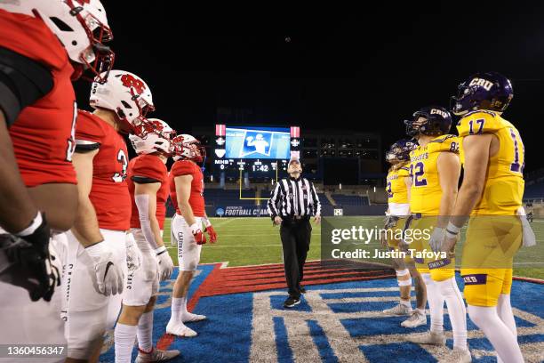 The captains of the Mary Hardin-Baylor Crusaders and the North Central Cardinals meet for the coins toss before the Division III Men's Football...