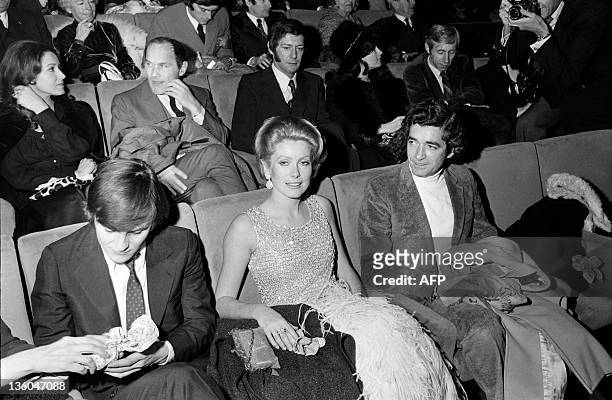 Photo taken on December 16, 1970 shows French actress Catherine Deneuve , flanked by film director Jacques Demy and actor Jacques Perrin , at the...
