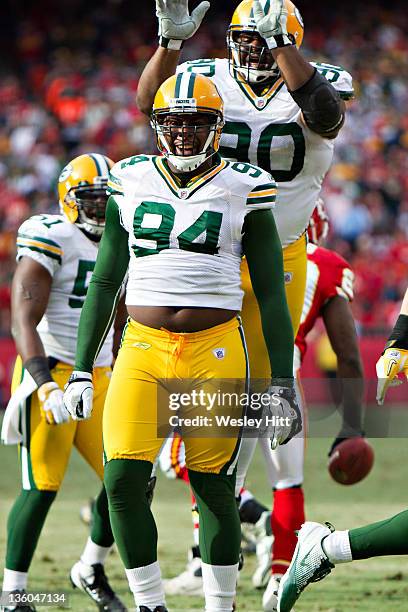 Jarius Wynn and B.J. Raji of the Green Bay Packers celebrate after a big play against the Kansas City Chiefs at Arrowhead Stadium on December 18,...