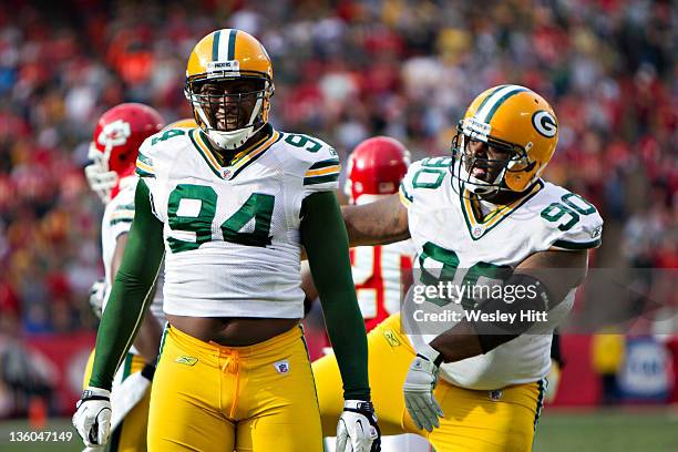 Jarius Wynn and B.J. Raji of the Green Bay Packers celebrate after a big play against the Kansas City Chiefs at Arrowhead Stadium on December 18,...