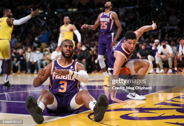 Chris Paul and Devin Booker of the Phoenix Suns fall as a foul is called on LeBron James of the Los Angeles Lakers at Staples Center on December 21,...