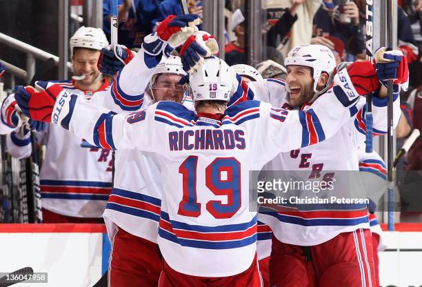 Ryan McDonagh, Brad Richards and Mike Rupp of the New York Rangers celebrate after Richards scored on a reviewed goal in the final second of the NHL...