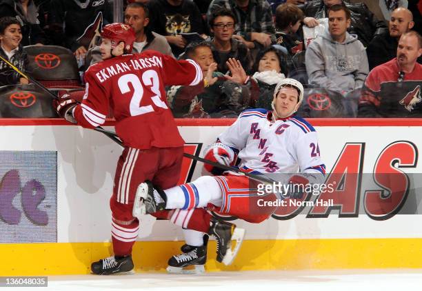 Ryan Callahan of the New York Rangers falls to the ice after being checked by Oliver Ekman-Larsson of the Phoenix Coyotes at Jobing.com Arena on...