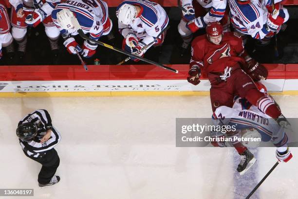 Oliver Ekman-Larsson of the Phoenix Coyotes is checked onto the bench by Ryan Callahan of the New York Rangers during the NHL game at Jobing.com...