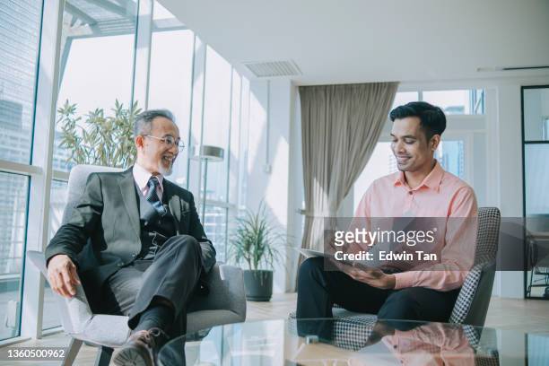 successful asian chinese senior manager talking to indian journalist interview - asian journalist stock pictures, royalty-free photos & images