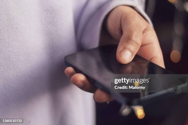 young man paying with credit card on his phone. online payment. - online bank service stock pictures, royalty-free photos & images