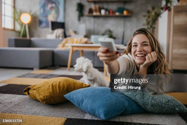 woman watching tv - watching television stock pictures, royalty-free photos & images