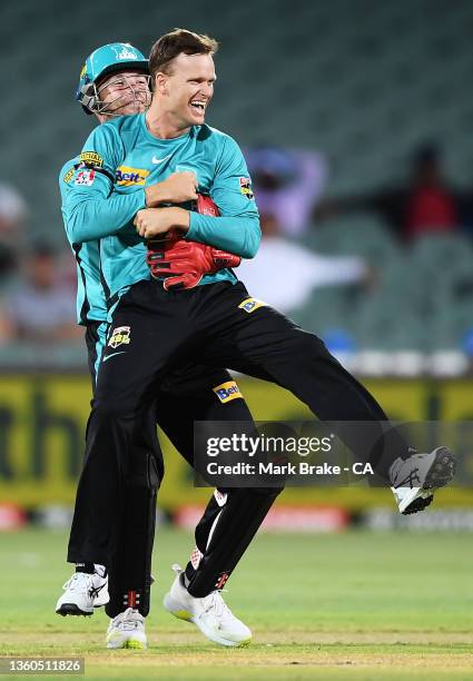 Matt Kuhnemann of the Heat celebrates the wicket of George Garton of the Strikers with Jimmy Peirson of the Heat during the Men's Big Bash League...