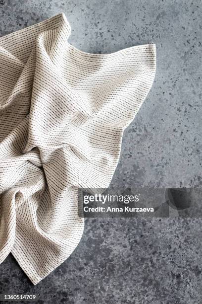 white and black linen striped napkin folded on grey concrete background, top view. copy space - straccio da cucina foto e immagini stock