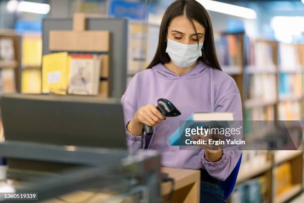 university student scanning a book in library - book barcode stock pictures, royalty-free photos & images