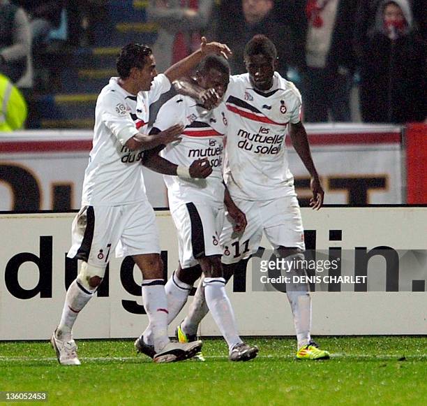 Nice's forward Franck Dja Djedje is congratulated by his teammates after scoring a goal during their French L1 football match Lille vs Nice on...