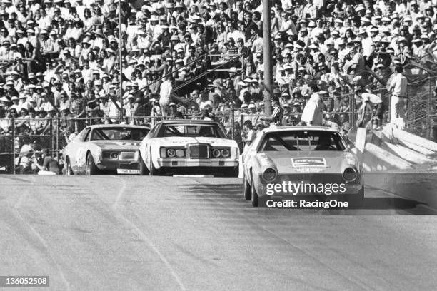 January 19, 1975: Bobby Allison in the Roger Penske AMC Matador leads the Mercury of David Pearson and the Dodge of Richard Petty on his way to...