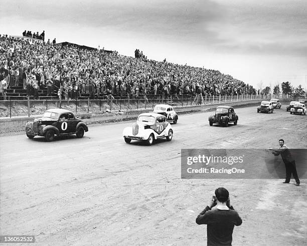 1950s: Action from an early 1950s NASCAR Modified race at Greensboro Fairgrounds. Jimmy Lewallen was driving car No. 0 while the No. 70 was driven by...