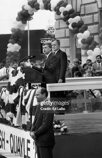 American politician Dan Quayle speaks from a lectern during a campaign rally, Huntington, Indiana, August 18, 1988. George HW Bush stands behind him....