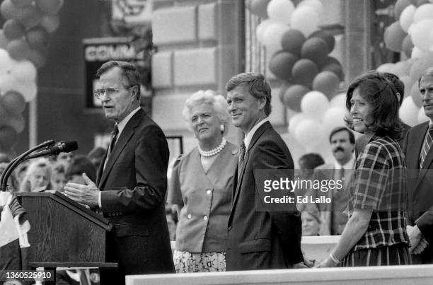American politician George HW Bush speaks from a lectern during a campaign rally, Huntington, Indiana, August 18, 1988. Among those also on the...