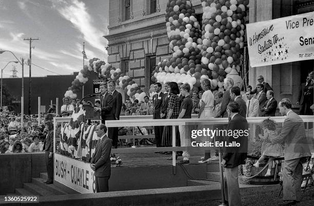 American politician Dan Quayle speaks from a lectern during a campaign rally, Huntington, Indiana, August 18, 1988. George HW Bush stands behind him....