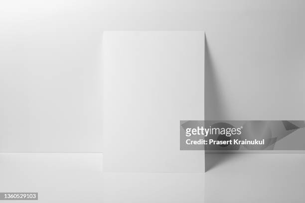 a4 white paper on white background - placard imagens e fotografias de stock