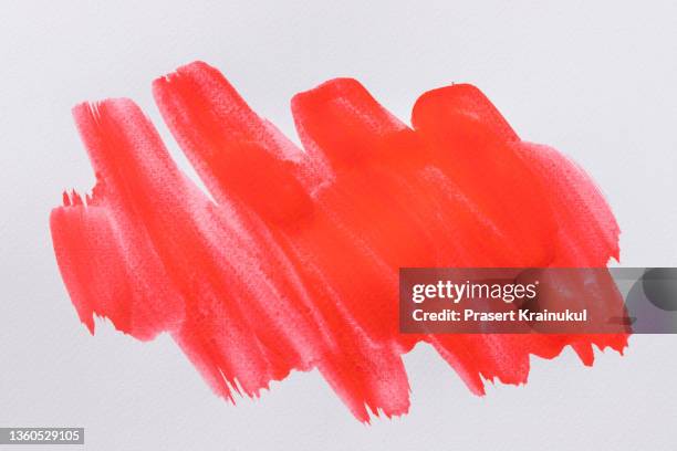 close up of red watercolor strokes painted on white background - red paint splash stock pictures, royalty-free photos & images