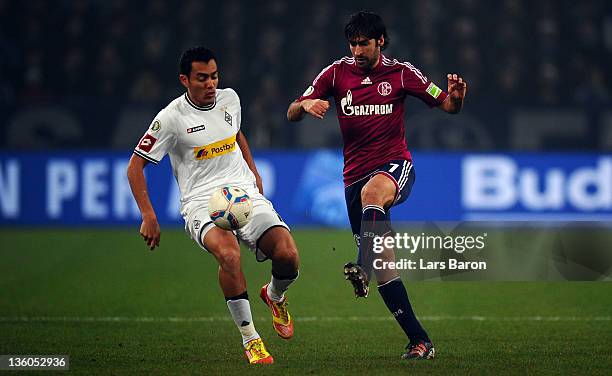 Juan Arango of Moenchengladbach challenges Raul Gonzalez of Schalke during the DFB Cup round of sixteen match between Borussia Moenchengladbach and...