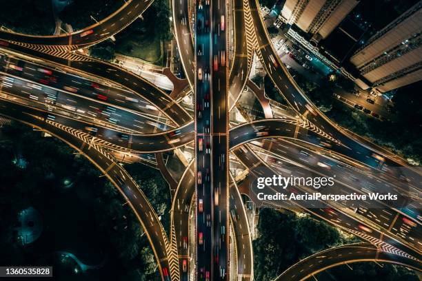 drone point view of overpass and city traffic at night - elevated road stock pictures, royalty-free photos & images