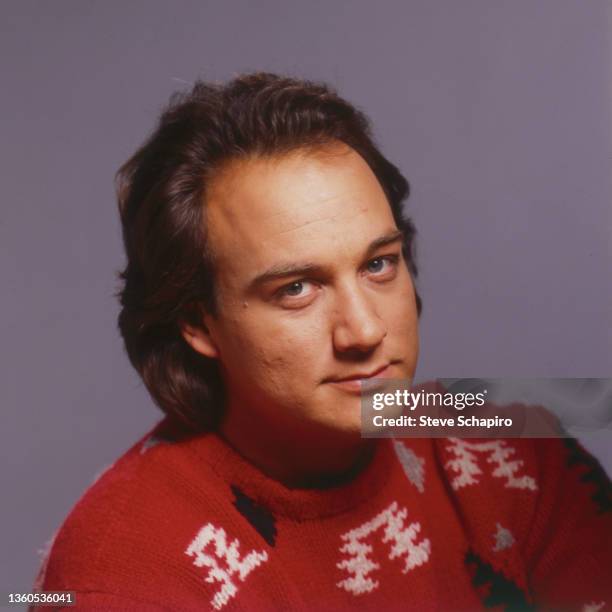 Portrait of American actor Jim Belushi as he poses in a knit sweater, Los Angeles, California, 1985.
