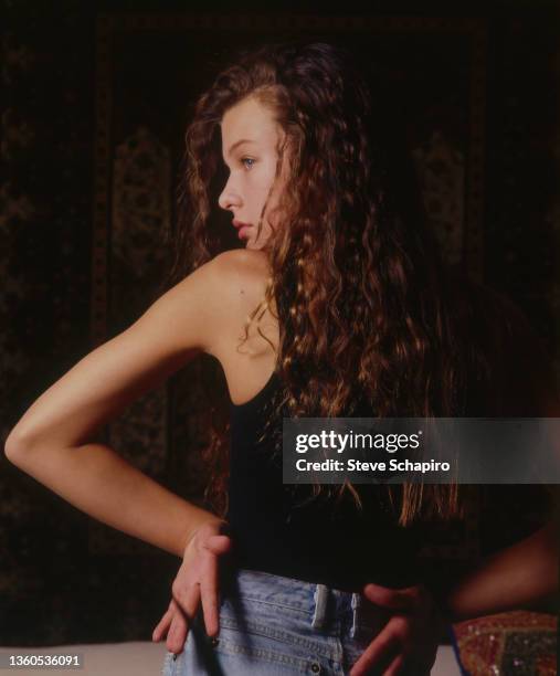 Portrait of teenaged Ukrainian actress and supermodel Milla Jovovich as she looks over her shoulder, Los Angeles, California, 1988.