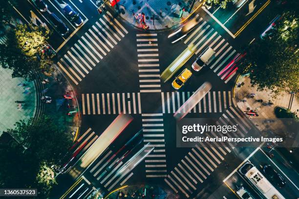 drone view of city street crossing at night - crossroad stock pictures, royalty-free photos & images