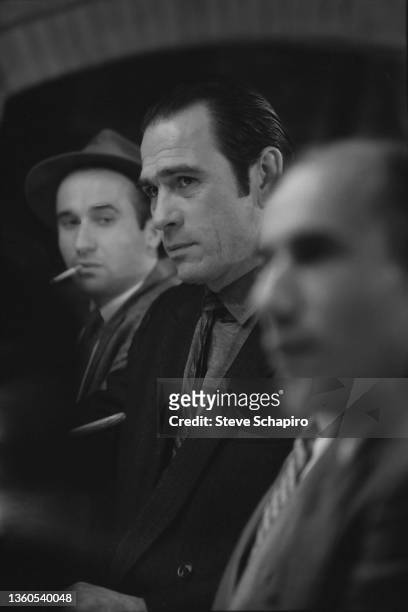 View of American actor Tommy Lee Jones , among others, in a scene from the film 'The Big Town' , Los Angeles, California, 1986.
