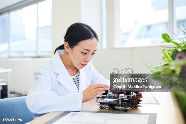 woman in robotics - robotics alive stock pictures, royalty-free photos & images