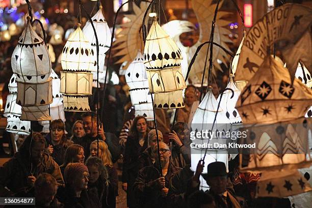 People carry lanterns at the Burning The Clocks Festival on December 21, 2011 in Brighton, England. The annual celebration is enjoyed by thousands of...