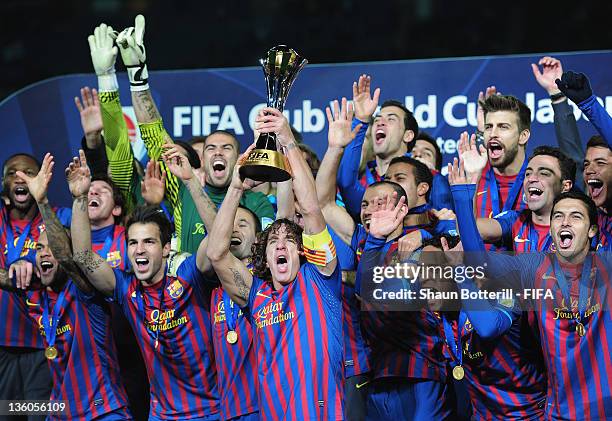 Barcelona captain Carles Puyol lifts the trophy with team-mates after the FIFA Club World Cup Final match between Santos and Barcelona at the...