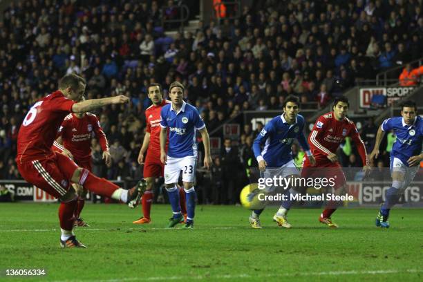 Charlie Adam L) of Liverpool fails to score from a penalty during the Barclays Premier League match between Wigan Athletic and Liverpool at the DW...